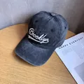 Dettaglio macro del ricamo Brooklyn e della trama lavata vintage sul cappellino grigio fumo - Nero Carbone