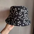 Detailed view of the corduroy floral pattern on the black reversible bucket hat for women - Size M (55-59cm) / Black
