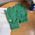 Detail of green knitted gloves with bear embroidery and functional finger openings - One Size / Green