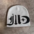 Detail of light grey knit beanie featuring black jacquard star and crescent moon patterns - M / Gray