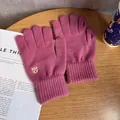 Detailed view of rose red knitted gloves with cute bear embroidery and finger openings - One Size / Rose Red