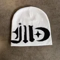 Close-up of gothic jacquard pattern and star-moon symbols on white knitted beanie - M / White