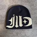 Close-up of black street style knit beanie with gothic letters and moon jacquard pattern - M / Black and Khaki Lettering