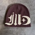 Flat lay of brown beanie with white jacquard moon and star knit patterns on stone background - M / Coffee