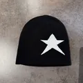 Close-up of the black knit beanie fabric showing detailed texture and white star pattern - M / Black With White Star