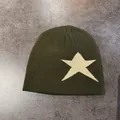 Detailed top view of olive green knit beanie with a white star on grey background - M / Army Green With Beige Star