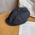 Close-up of dark grey cotton newsboy cap with white OLD SCHOOL embroidery on wood table - M (55-59cm) / Navy Blue
