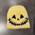 Close-up detail of fluffy yellow knit beanie with a spooky black embroidered smiley face - M (54-59cm) / Yellow
