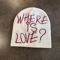 Detail of white knit beanie featuring red WHERE IS LOVE? embroidery with heart detail - M (52-58cm) / White with Wine Red Letter