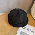 Detail of a black distressed Miki hat featuring torn fabric texture and knitted brim edges - Adjustable / Black