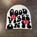 Close-up of knit beanie showing Good Vibes Only text and melting smiley faces - M / White