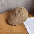 Detail of a brown plaid newsboy cap with textured fabric and vintage check patterns - M (55-59cm) / Khaki