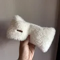 Detail of soft white plush headband with a decorative gold-tone metal logo plate - White