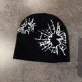 Detail of black knitted beanie featuring white spider web pattern and ribbed texture - M (52-58cm) / Black