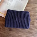 Detail of navy blue ribbed knit headband texture on a minimalist wooden background - Navy Blue