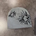 Macro view of ice blue knit beanie showing detailed texture and black pixelated print - M (52-58cm) / Grey Black
