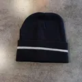 Detail view of black ribbed knit beanie featuring a reflective safety stripe on the cuff - M (52-58cm) / Black