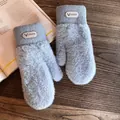 Detail view of plush gray mittens featuring a ribbed wrist and branded leather logo patch - One Size / Blue