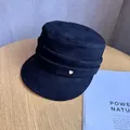 Close-up of black suede flat top hat with layered fabric bands and golden heart buckle - M (55-59cm) / Black