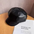 Close-up of black PU leather baker boy hat showing textured finish and top button detail - M (55-59cm) / Black