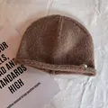 Close-up of deep brown knit beanie with rolled edge and silver seven metal plate - M (55-59cm) / Camel