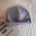Detail of soft purple knit beanie featuring a roll-up edge and a metallic Seven tag - M (55-59cm) / Blue and Purple