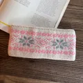 Detail of knitted winter headband with Nordic snowflake patterns and ribbed edges - Beige Pink Snowflake Style / Pink