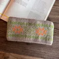Detail of wide knit headband with green geometric jacquard and orange snowflake pattern - Brown Orange Green Pattern Style / Khaki