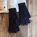 Close-up of soft black plush knit gloves with warm texture on wooden background - One Size / Black