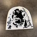 Close-up of white knitted beanie featuring a black religious portrait jacquard pattern - M / White