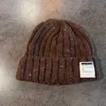 Detail of chunky knit beanie with white logo patch and textured salt and pepper yarn - Coffee / Elastic
