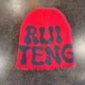 Close-up of red faux mink fur beanie with navy blue RUI TENG knitted letter pattern - M (54-59cm) / Watermelon Red and Gray Letters