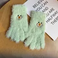 Close-up of light green plush winter gloves with cute smiley face embroidery detail - One Size / Green