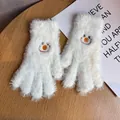 Close-up of white plush gloves with embroidered smiley face and thick fuzzy texture - One Size / White