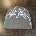 Close-up of the dark grey knitted beanie featuring white jacquard tribal spider patterns - M(54-58cm) / Gray