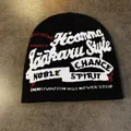 Detail of black street style knit beanie featuring red and white jacquard graphic patterns - M / Black