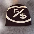 Detail of dark brown beanie with white knitted dollar sign and letter pattern - M (54-59cm) / Coffee