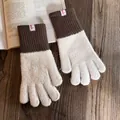 Close-up of contrast color knitted winter gloves with soft plush texture on wooden table - One Size / Beige
