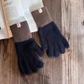 Detail von gestrickten Handschuhen mit Smile-Label auf gemütlichem Holzgrund - Schwarz