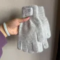 Detail of grey rabbit fur knit glove showing soft texture and decorative woven label - Light Gray