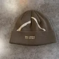 Detailed view of dark olive knit beanie featuring white wave pattern and letter embroidery - M (55-59cm) / Coffee