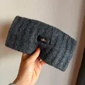 Close-up of thick dark grey knitted headband with a premium leather logo patch - Dark Gray