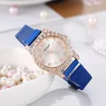 Close-up of rose gold star-patterned dial and blue magnetic mesh band on pearl backdrop - Blue