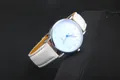 Detail of white leather watch strap and silver Roman numeral dial with blue hands - White Strap White Dial