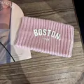 Détail d'un bandeau de sport en tricot rose avec broderie blanche Boston 1630 - Rose