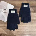 Detail of dark blue waffle knit gloves with touch screen fingertips on wooden background - One Size / Navy Blue