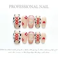 Faux ongles œil de chat bleu avec motif vache, nœuds rouges et breloque ours 3D - XS / Style Y2K