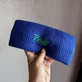 Close-up of royal blue knitted sports headband with green Boston 1987 embroidery - Sapphire Blue