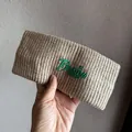 Close-up of oatmeal knitted headband featuring green Boston EST. 1987 embroidery detail - Mocha