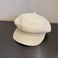 Detail of cream newsboy hat showing texture fabric crown and smooth faux leather brim - M (55-60cm) / Off White